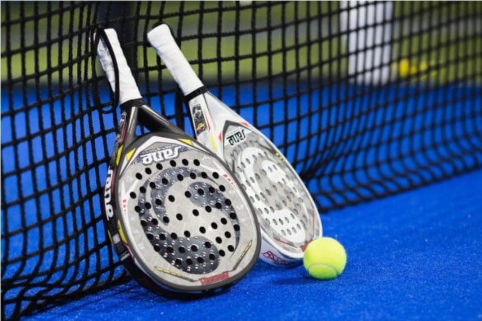 Padel rackets and ball on the court